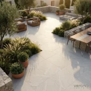 Outdoor patio with grey stone look porcelain tiles and outdoor furniture.