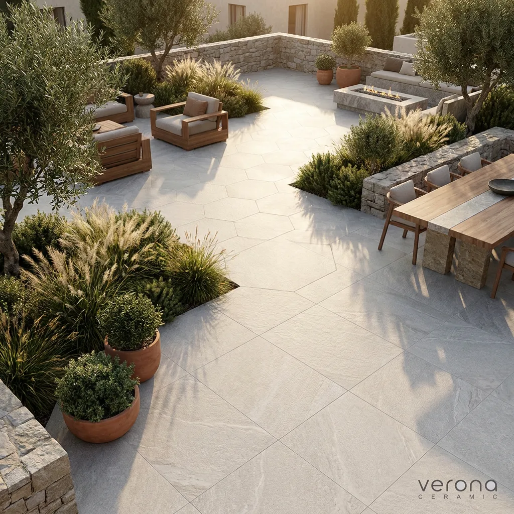 Outdoor patio with grey stone look porcelain tiles and outdoor furniture.