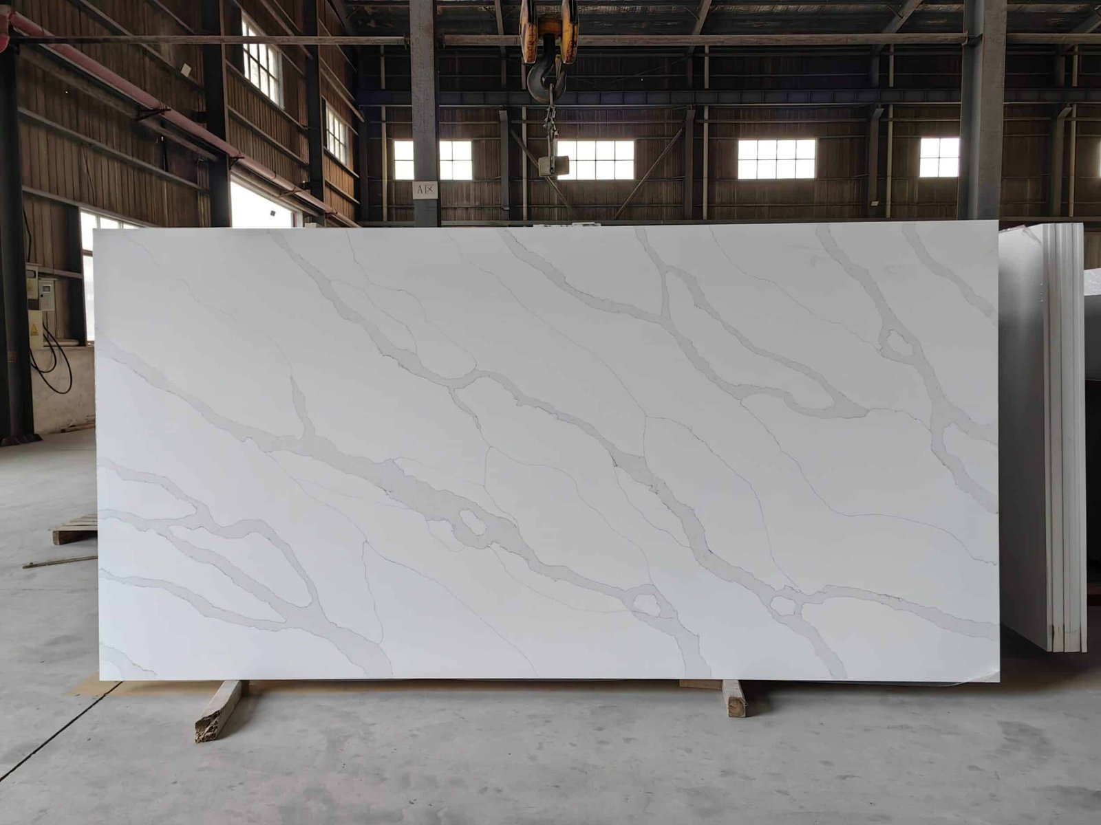 Golden Silk engineered stone slab with delicate grey veining, jumbo slab application for kitchen benchtops.