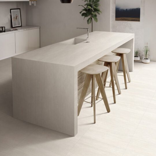 Blossom Taupe Matt Porcelain Tile flooring in modern kitchen design with island and bar stools.