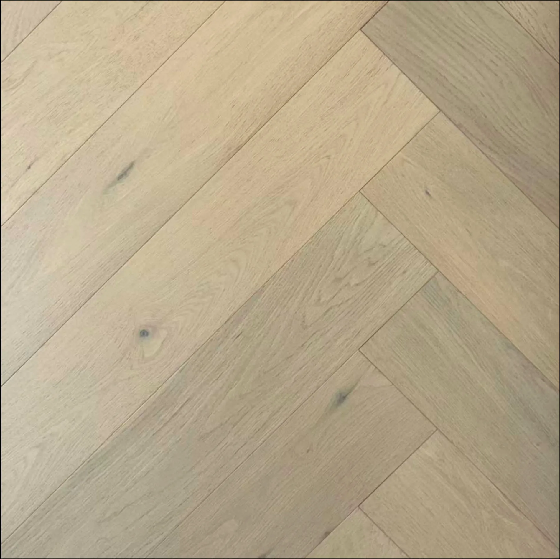 European oak herringbone flooring pattern showcasing wide-plank design and micro bevel edges.